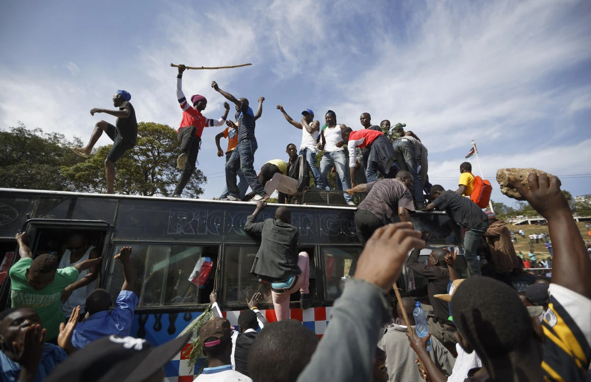 Supporters of opposition leader Raila Odinga arrive by bus, as they gather in advance of a mock "swearing-in" ceremony of Odinga at Uhuru Park in downtown Nairobi. (AP)