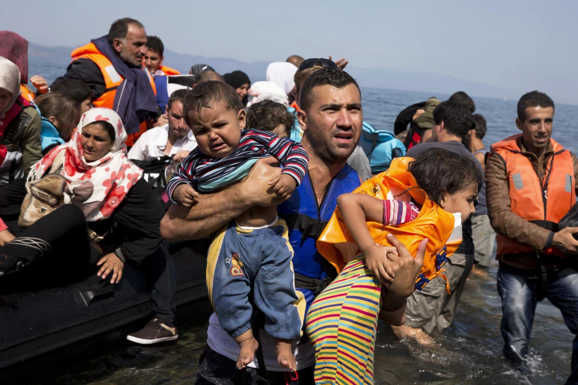Syrian migrants arrive on the Greek island of Lesbos. Migrants, including 11 Syrians, were picked up from an Italian trawler on Tuesday and taken by the Montenegrin coast guard to the port of Zelenika. (AP)