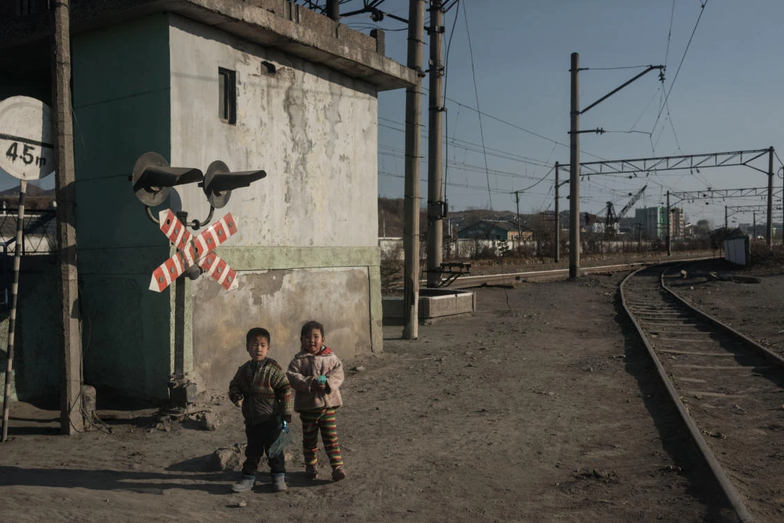 Children stand besides a railway track in the industrial city of Chongjin on North Korea's northeast coast. (AFP)