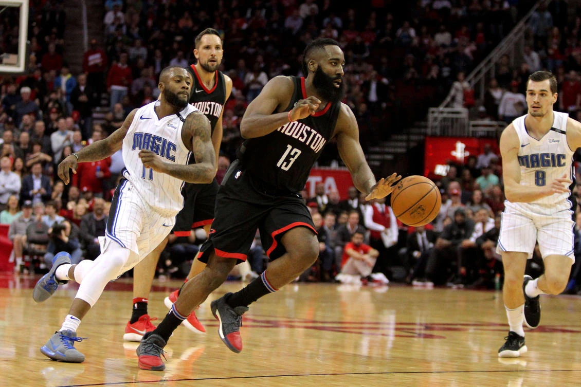 Houston Rockets guard James Harden dribbles past Orlando Magic players during the fourth quarter of their NBA game at Toyota Center. (USA TODAY Sports)
