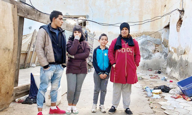 Wahida with her children. They stay in a disused building in Sidi H’Cine, Tunis. She said Tunisia’s austerity law is making life even harder. (Photo by Eliza Volkmann)