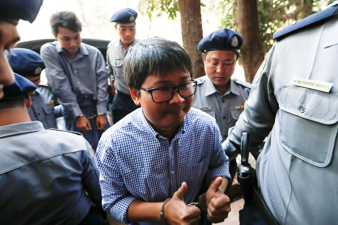 Detained Reuters journalist Wa Lone and Kyaw Soe Oo are escorted by police while arriving for a court hearing in Yangon on February 1. (Reuters)