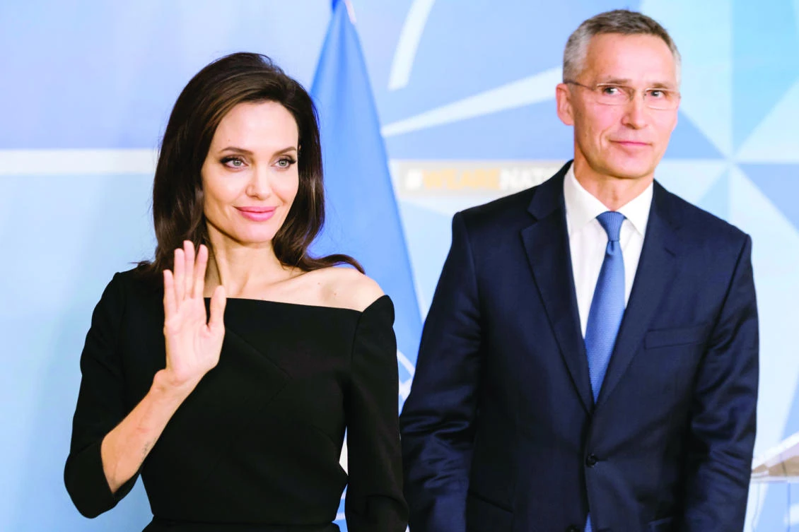 NATO Secretary-General Jens Stoltenberg with Angelina Jolie, special envoy for the UN High Commissioner for Refugees. (AP)