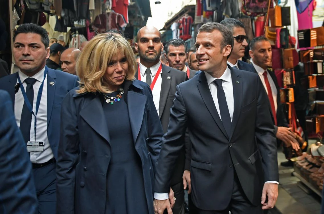 Emmanuel Macron and his wife Brigitte walk through the medina (old town) of the Tunisian capital Tunis. The French president has pledged more than €270 million in new financing for Tunisia. (AFP)