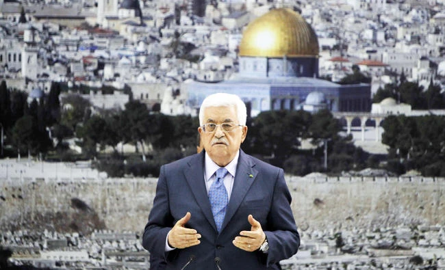 A file photo taken on July 22, 2014 shows Palestinian Authority president Mahmud Abbas addressing journalists as he meets with members of the Palestine Liberation Organization (PLO) in the West Bank city of Ramallah, after he prayed for the Palestinians who were killed during the Israeli military offensive in the Gaza Strip. (AFP)