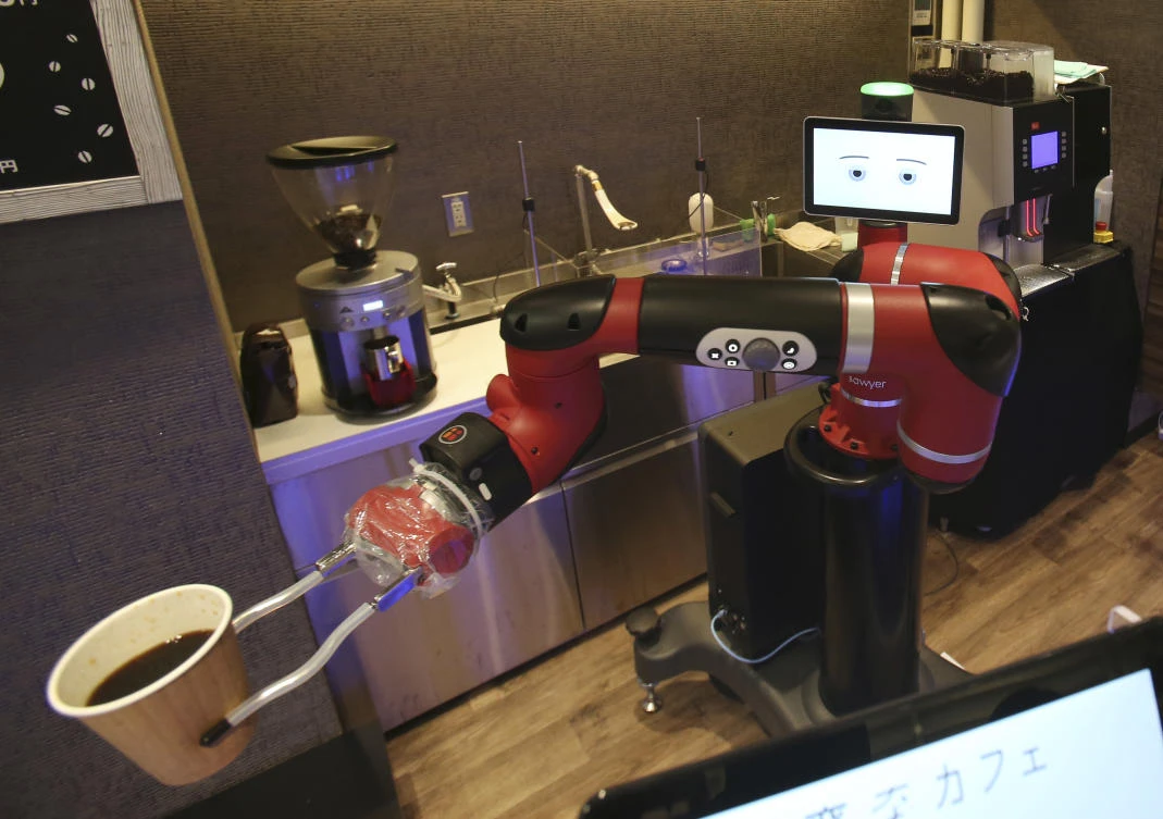 Robot barista named "Sawyer" makes a coffee at Henn-na Cafe, Japanese meaning "Strange Cafe"in Tokyo, Friday, Feb. 2, 2018. (AP)