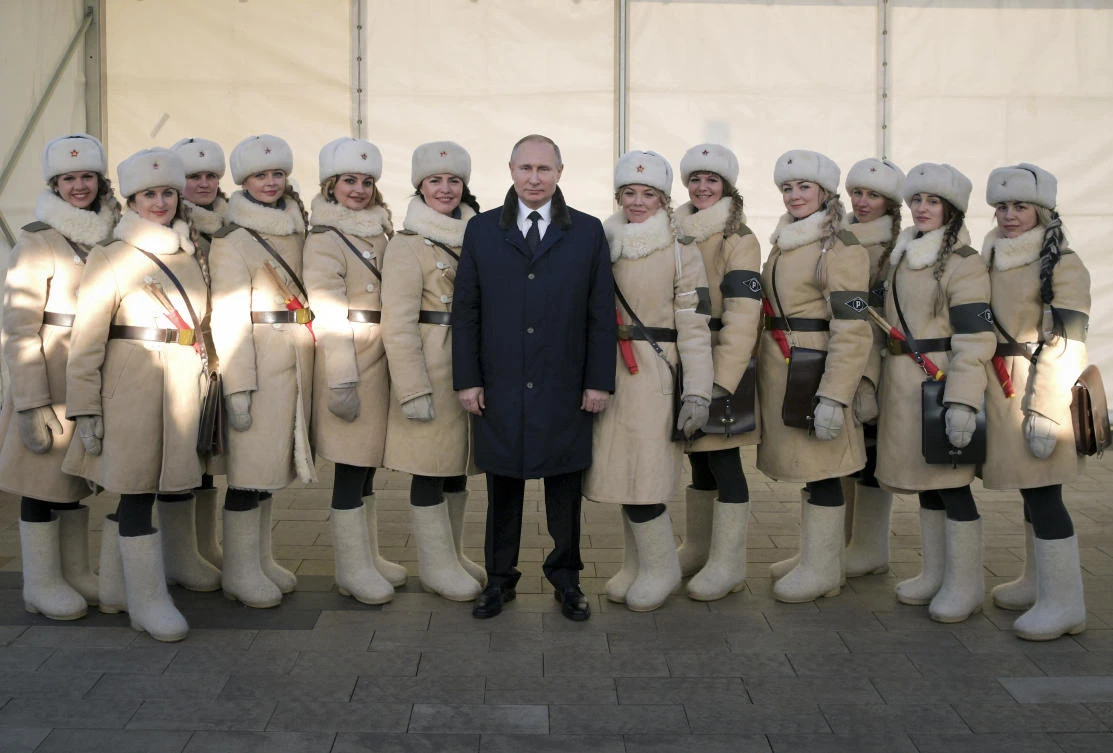 President Vladimir Putin, center, poses for a picture alongside women dressed in historic Red Army uniforms during commemorations of the 75th anniversary of the Battle of Stalingrad in the southern Russian city of Volgograd, once known as Stalingrad. (AP)