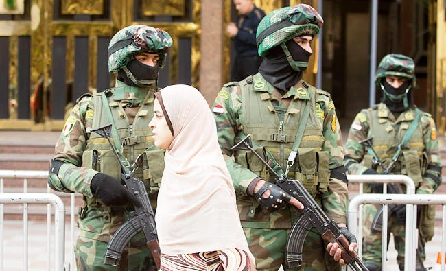 A girl walks past special forces soldiers as they take positions in front of the National Election Authority, which is in charge of supervising the 2018 presidential election, in Cairo, Egypt, in this Jan. 29, 2018 photo. (AP)