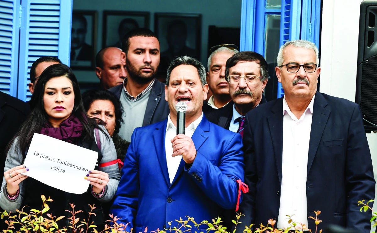 Neji Bghouri, president of the National Union of Tunisian Journalists (SNJT), speaks during Friday’s demonstration at the SNJT headquarters against police threats and intimidation in Tunis. (AFP)