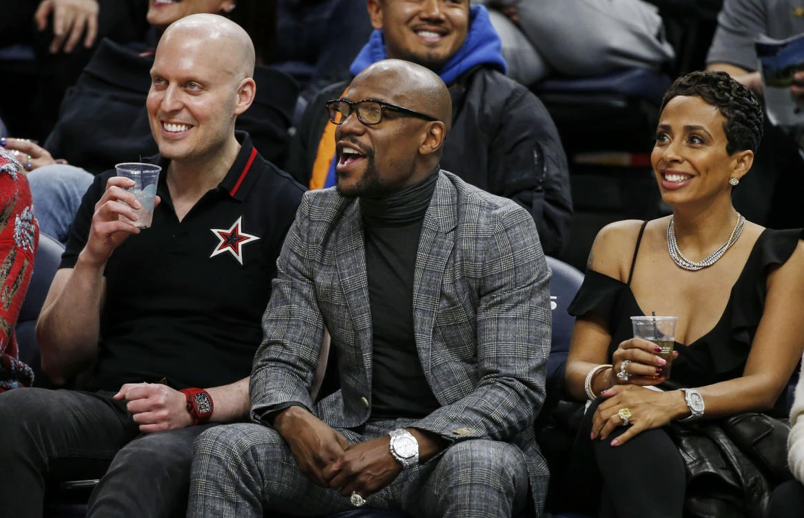 Former boxing champion Floyd Mayweather (C) watches the game between the Milwaukee Bucks and the Minnesota Timberwolves at Target Center. (Bruce Kluckhohn-USA TODAY Sports)