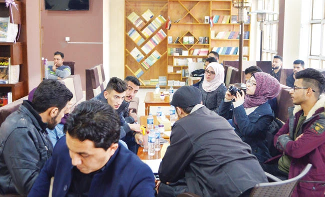 Iraqis gather at Book Forum, a cultural café, in Mosul. (AFP)