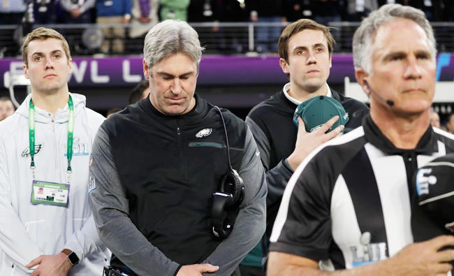 Philadelphia Eagles head coach Doug Pederson, second from left, listens to the national anthem before the NFL Super Bowl 52 football game against the New England Patriots on Sunday, in Minneapolis. (AP)