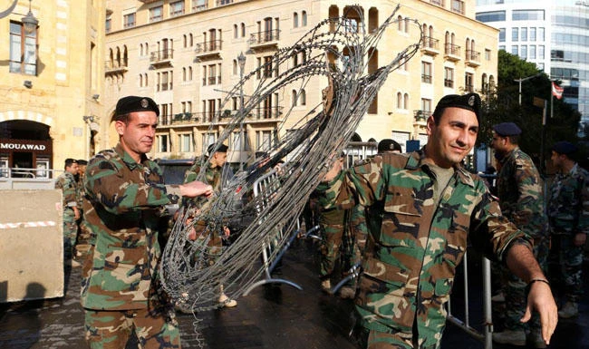 Lebanon has mostly escaped the rash of militant assaults around the Middle East spurred by the war in its neighbor Syria. Above, army soldiers install barb wire in downtown Beirut for security protection. (Reuters)