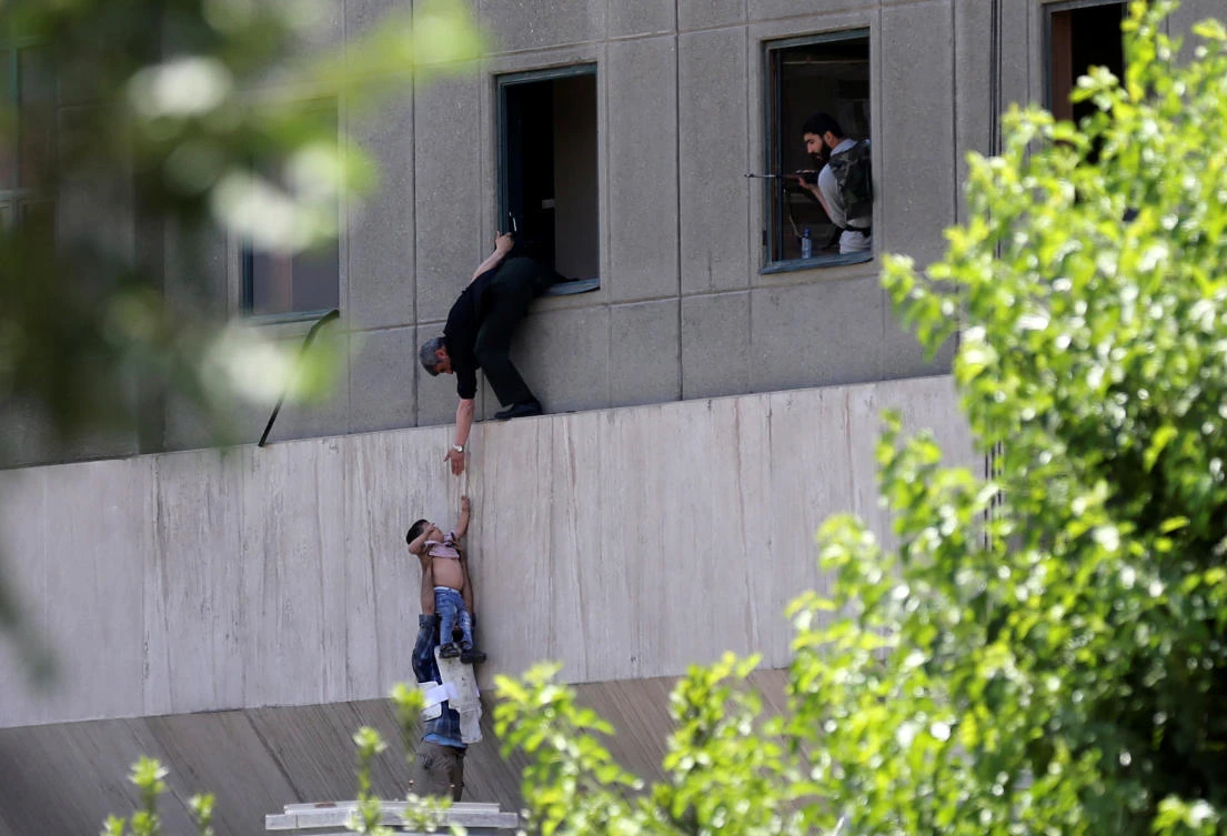 Above, a boy is evacuated during an attack on the Iranian parliament in central Tehran on June 7, 2017. (Reuters)