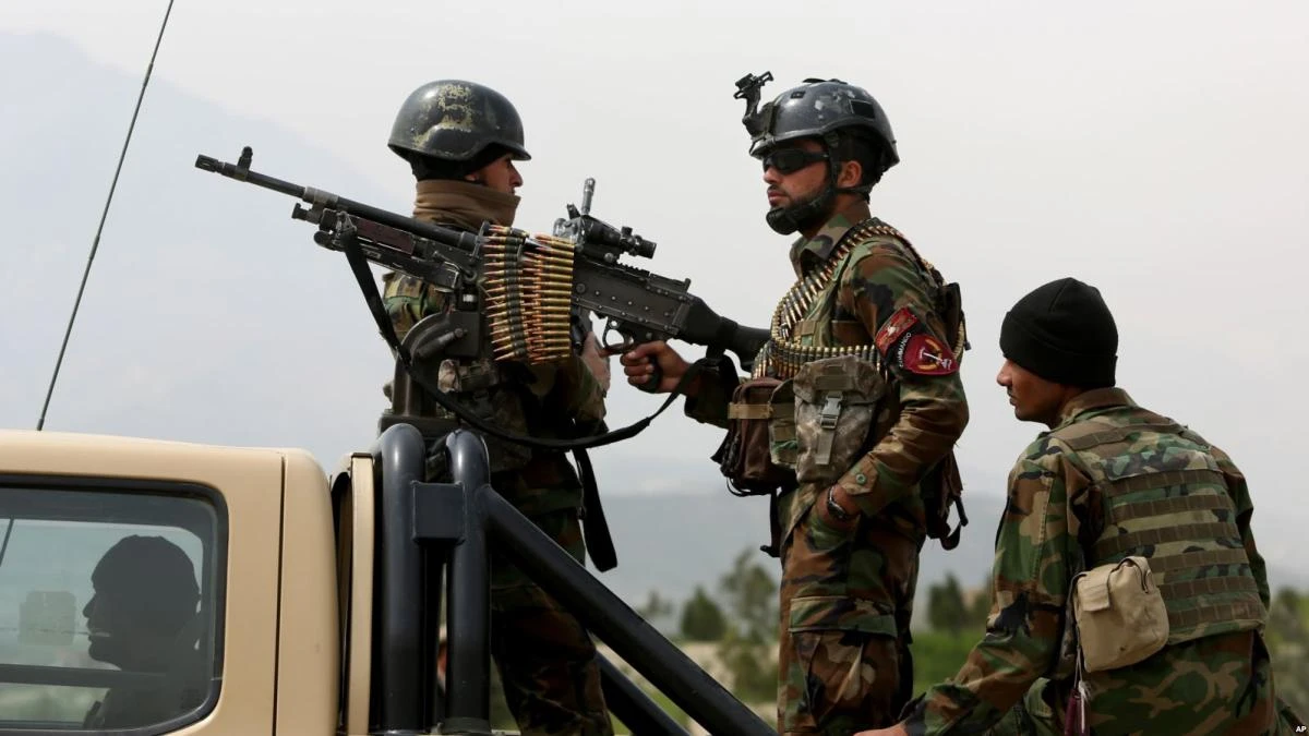 Afghan military soldiers stand stand alert at the entrance gate of the new parliament building after a rocket attack in Kabul, Afghanistan. (AP)
