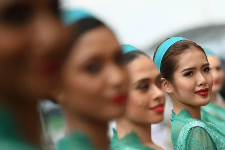 Grid girls pose for photographs before the start of the Formula One Malaysia Grand Prix in Sepang on October 1, 2017. (AFP)