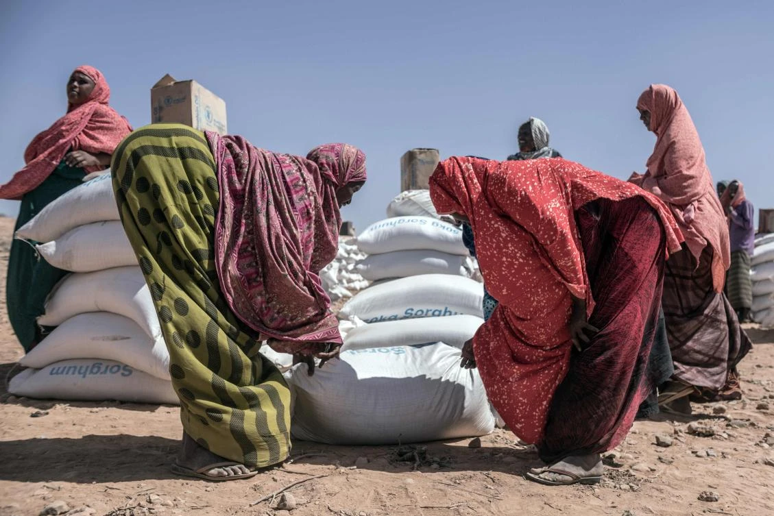 Women collect supplies brought by the World Food Programme at a displaced persons camp near Kebri Dahar in southeastern Ethiopia. The camp hosts Somali families fleeing conflict between Somali and Oromo communities in the country. (AFP)