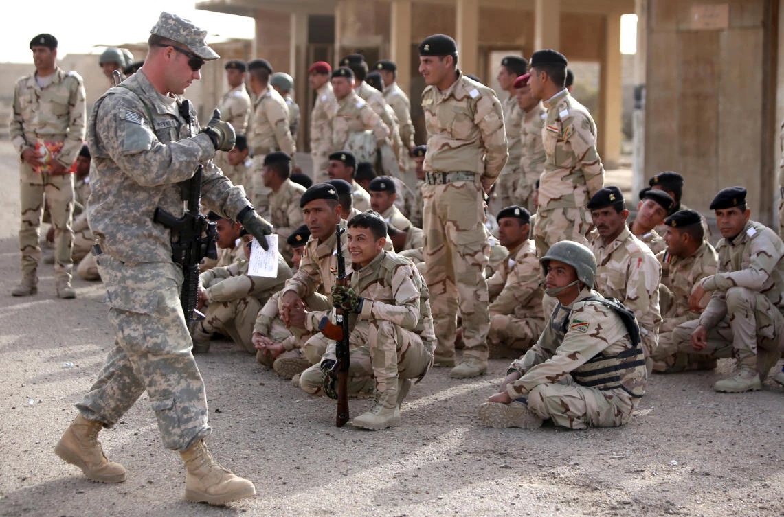 An American military trainer gives a thumbs up to an Iraqi soldier during an exercise on approaching and clearing buildings at the Taji base complex, which hosts Iraqi and US troops and is located north of the capital Baghdad. (AFP)