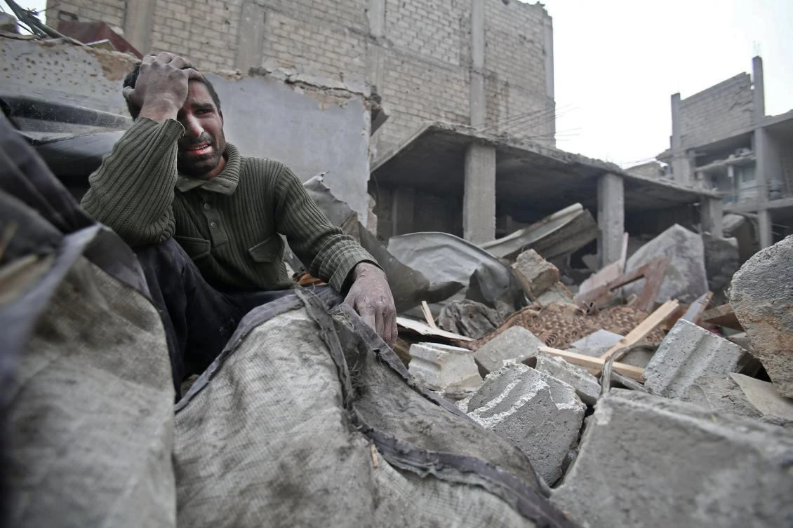 A Syrian man mourns over his home destroyed by airstrikes in the Eastern Ghouta region on the outskirts of Damascus on Sunday. (AFP)