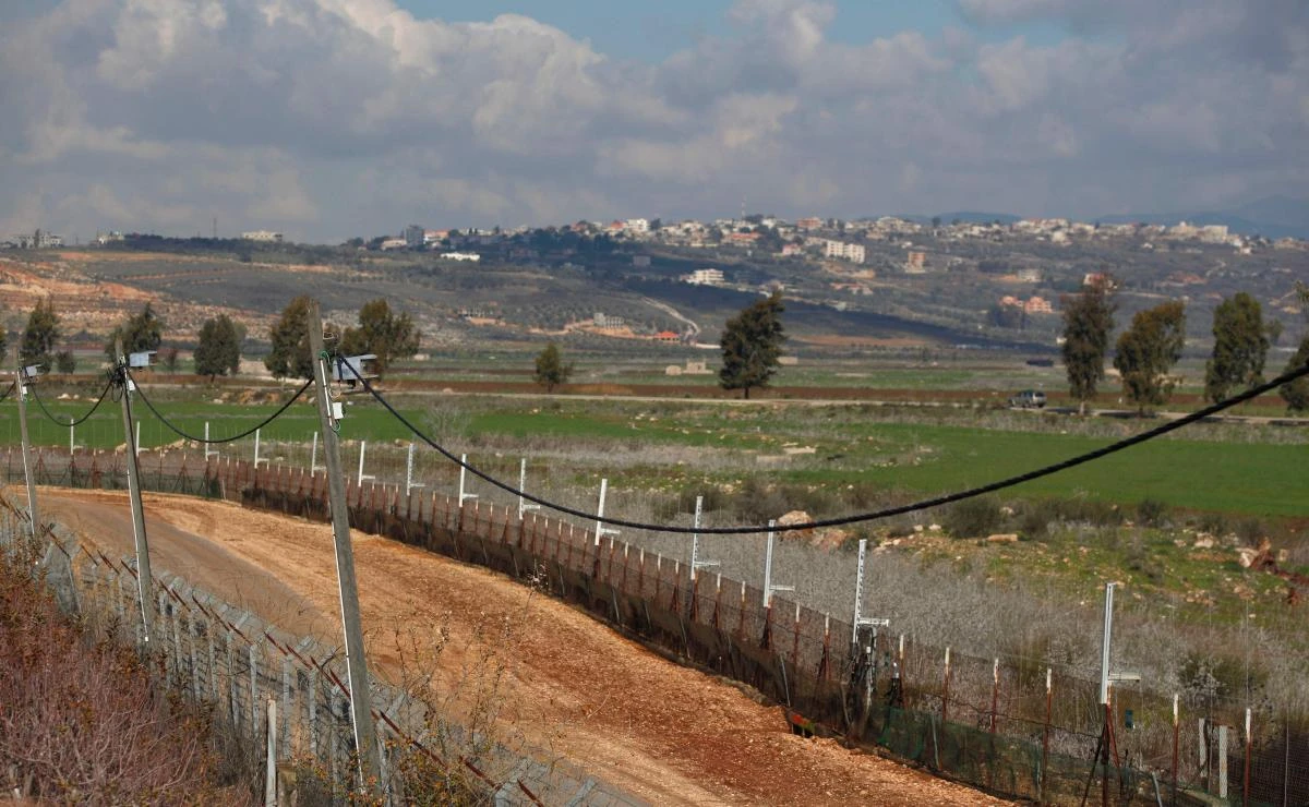 A picture taken from the Israeli town of Metula on January 30, 2018 shows the border fence between Israel and Lebanon with the southern Lebanese village of Kfar Kila on the background. (AFP/Jalaa Marey)