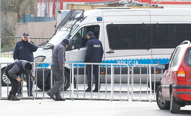 City workers putting up barriers around the Israeli Embassy in Warsaw, Poland, in this Jan. 31, 2018 photo, after a local governor, citing security concerns, banned traffic in the area in order to prevent a planned protest by far-right groups amid a spat between Poland and Israel. (AP)