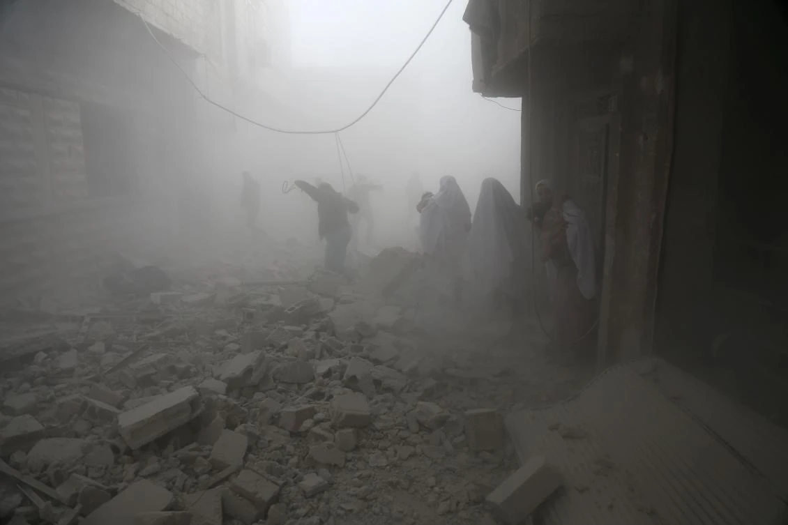 Syrian flee their homes following an airstrike in the rebel-held besieged town of Arbin, in the eastern Ghouta region on the outskirts of the capital Damascus on February 2, 2018. (AFP)
