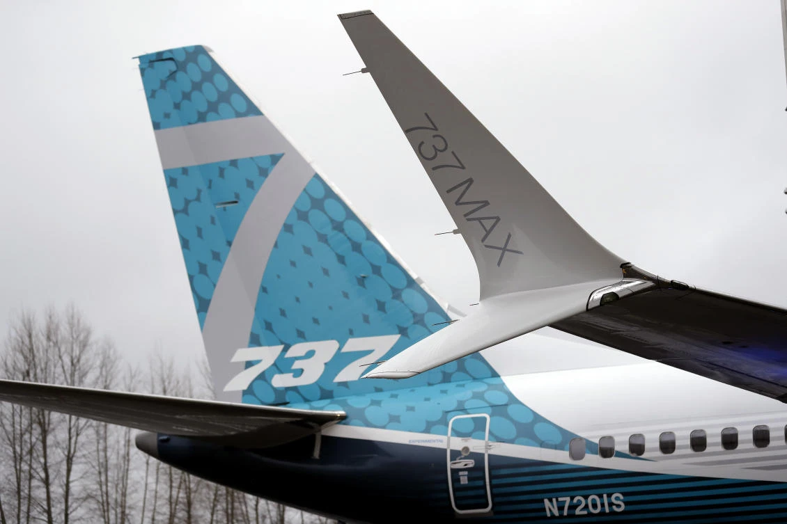 A dual-tipped wing tip, known as a “winglet,” stands in view of the tail of a Boeing 737 MAX 7, the newest version of Boeing’s fastest-selling airplane, during its debut on Monday, February 5 in Renton, Washington. (AP)