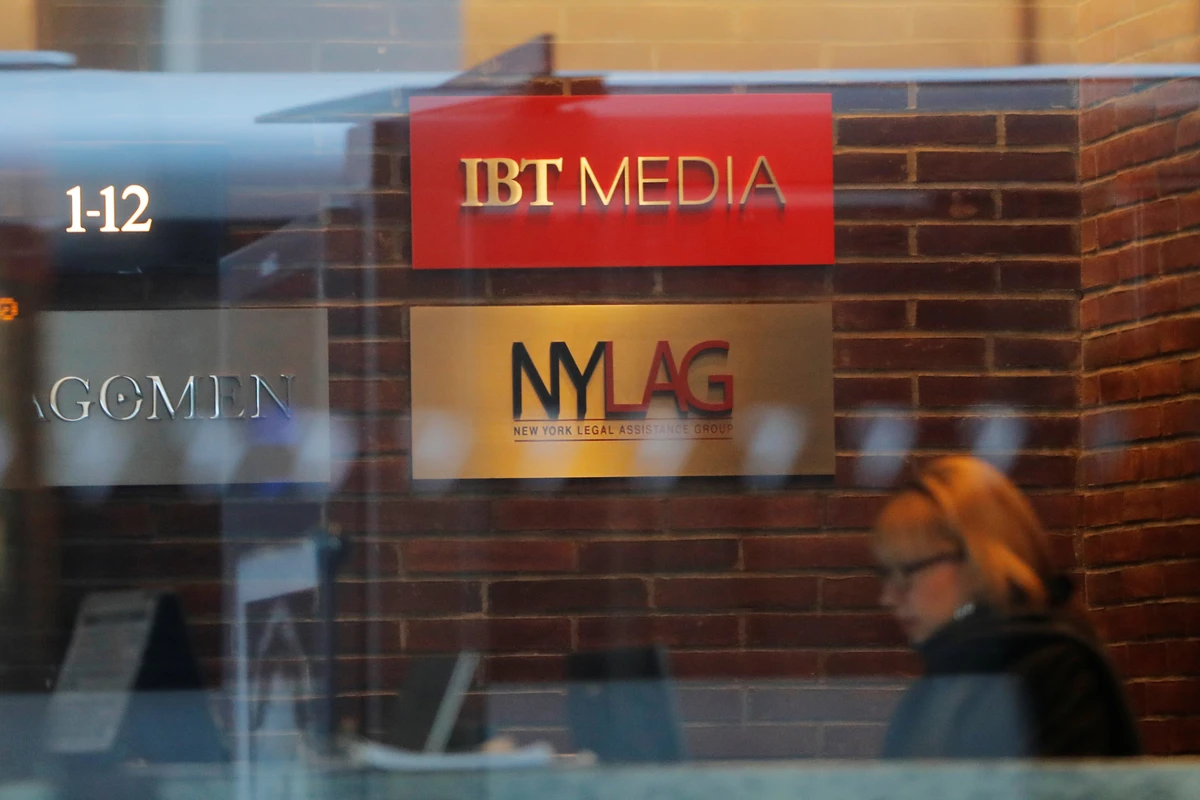 A woman works at a desk inside of the building containing IBT Media, parent company of Newsweek Media Group, in New York. (Reuters)