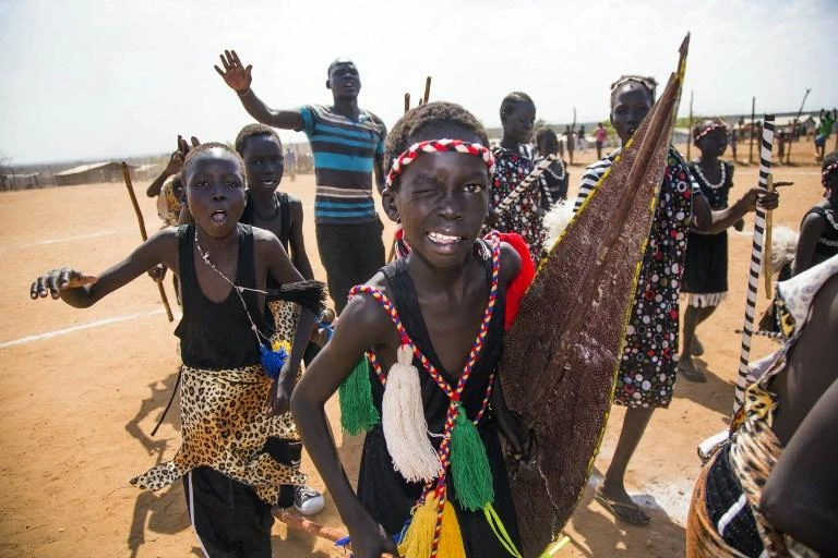 Displaced children perform cultural songs to welcome the visit of US actor Forest Whitaker at the UN Protection of Civilians (PoC) site in South Sudan. (AFP)