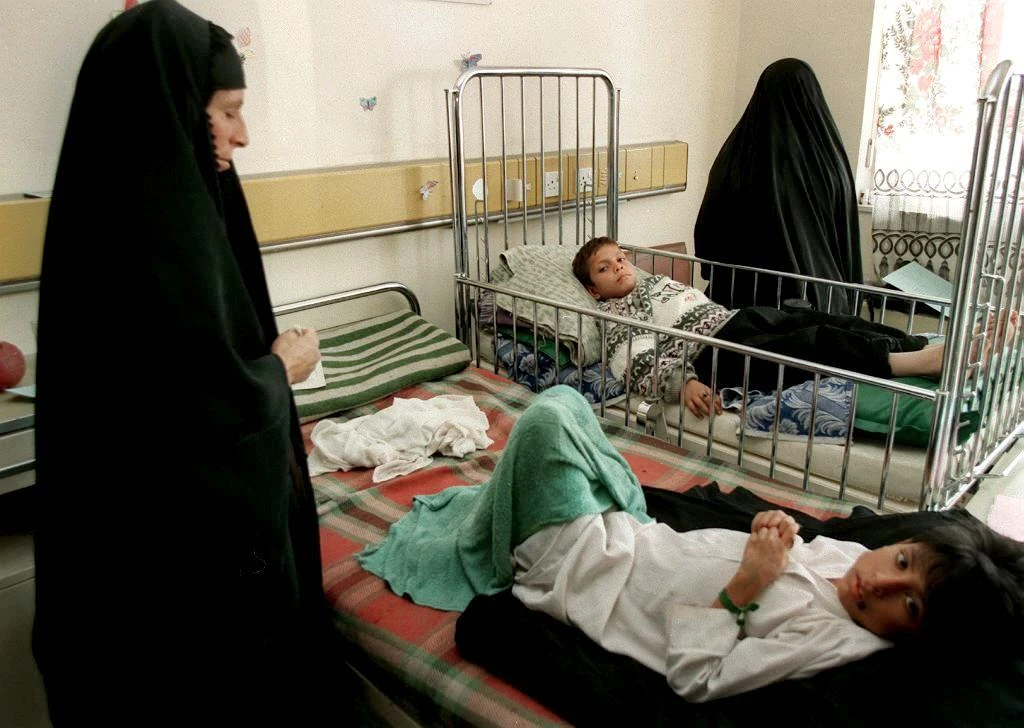 Two Iraqi mothers watch over their children at the Saddam Hussein hospital in Baghdad. (File Photo: AFP)