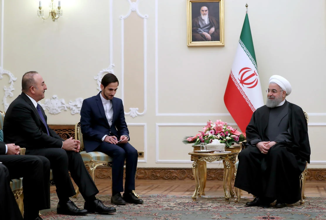 A handout picture provided by the Iranian presidency official website on Feb. 7, 2018 shows President Hassan Rouhani (R) meeting with Turkish Foreign Minister Mevlut Cavusoglu (L) in the capital in Tehran. (AFP/Iranian Presidency)