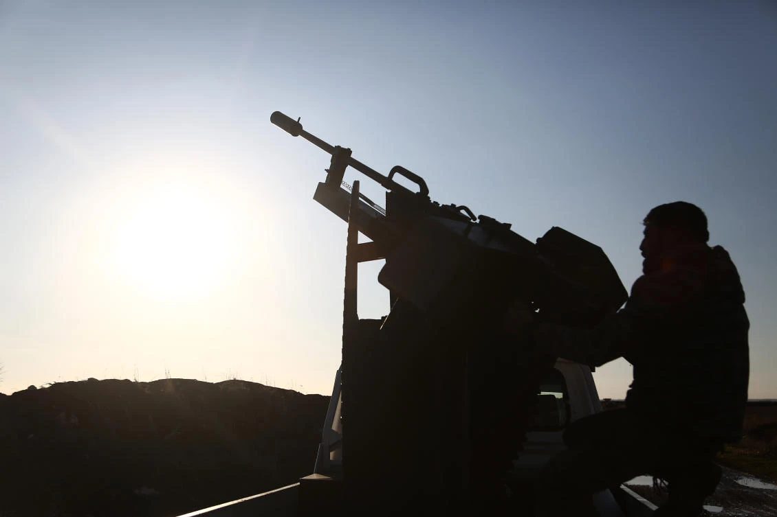 Turkish-backed fighters from the Free Syrian Army hold a position in the Tal Malid area, north of Aleppo, as they prepare to target Kurdish People's Protection Units (YPG) positions in the area of Afrin, on Jan. 20, 2018. (Nazeer al-Khatib / AFP)