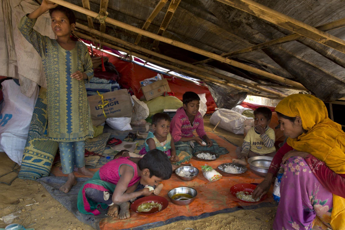 A newly arrived Rohingya family eats at the Balukhali refugee camp near Cox's Bazar, Bangladesh. (AP Photo/Manish Swarup)