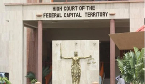 Ibrahim Tumsah, finance and account director at the Power, Works and Housing Ministry was arraigned at Abuja Federal High Court, above, along with his brother Tijani Tumsah. (dnllegalandstyle)