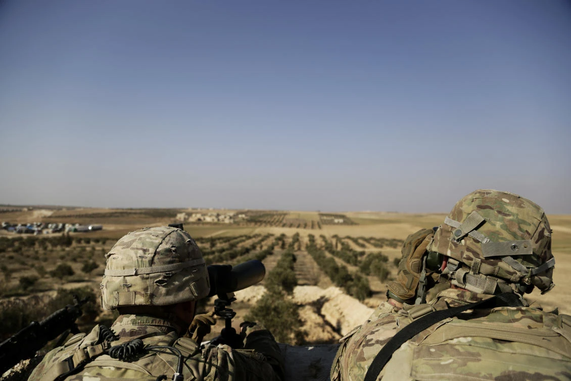 American troops look out toward the border with Turkey from a small outpost near the town of Manbij in northern Syria. (AP)