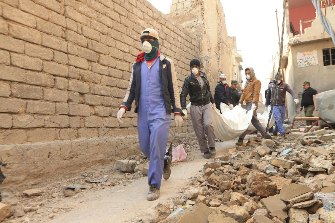 Local residents remove bodies from the rubble in the Old City of Mosul. Cities across Iraq have been destroyed by years of war with as much as $100 billion needed for the reconstruction effort. (Reuters)