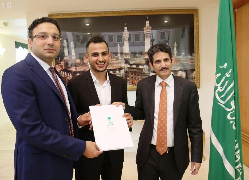 Ahmed Al-Mohimeed received an award from the charge d'affaires of the Saudi Arabian embassy in Australia for saving an elderly man from drowning. (SPA)