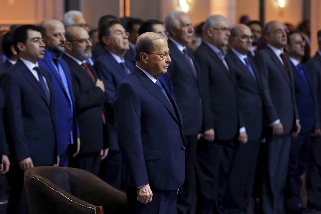 Lebanese President Michel Aoun, center, stands for the national anthem of Lebanon during the signing ceremony with an international consortium to start exploratory offshore drilling for oil and gas in Beirut. The ceremony was attended by officials from the consortium’s three oil companies, Italy’s Eni, France’s Total and Russia’s Novatek. (AP Photo)