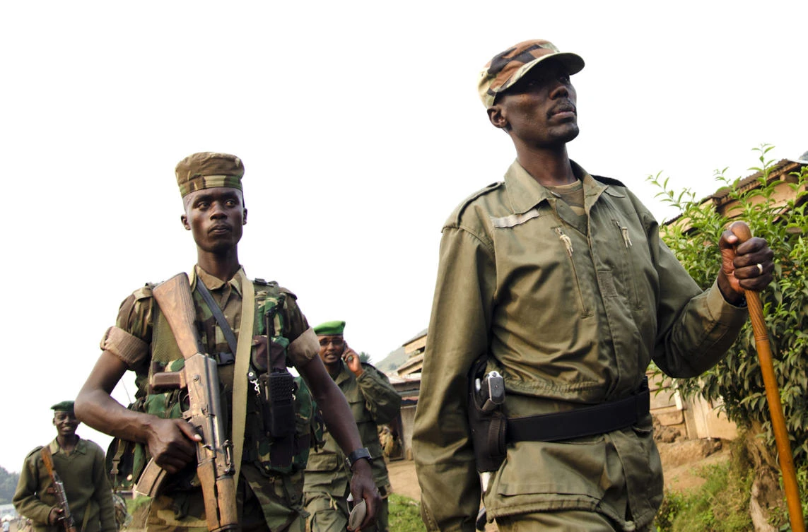 This photo taken on July 8, 2012, shows Col. Sultani Makenga (R), head of the rebel M23 group, followed by soldiers and walking in Bunagana, a town near the Ugandan border. The United States ordered sanctions on Sultani Makenga, the head of the M23 rebels in the Democratic Republic of the Congo, on November 13, 2012, for his role in atrocities in the country. (AFP)