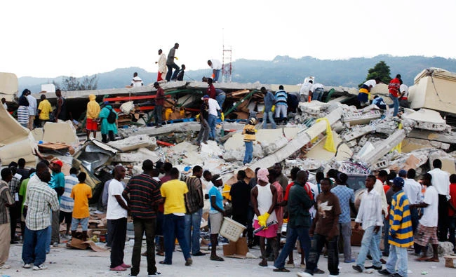Resident search for survivors among the debris after an earthquake in Port-au-Prince, in this January 13, 2010 file photo. (REUTERS)