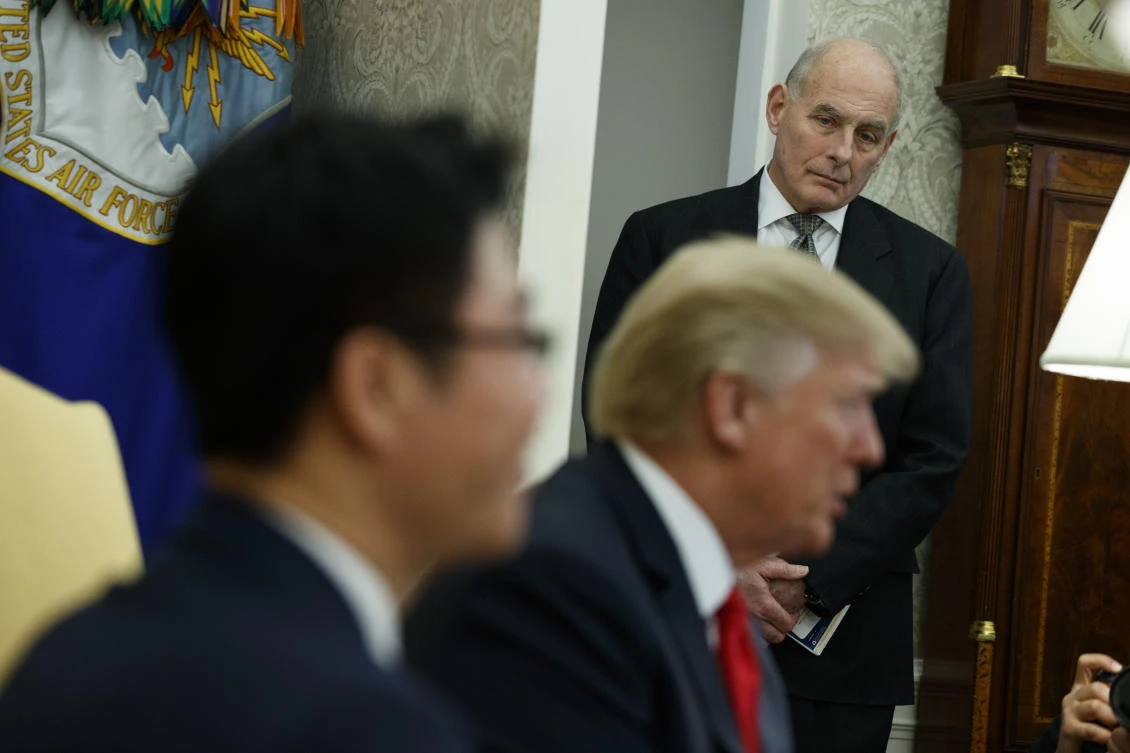Amid a White House in tumult, Trump defends former aide