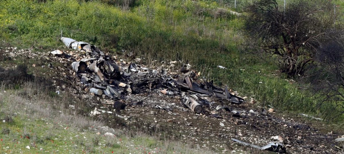 A picture taken in the northern Israeli Kibbutz of Harduf on February 10, 2018, shows the remains of an Israel F-16 that crashed after coming under fire by Syrian air defenses during attacks against “Iranian targets” in the war-torn country. (AFP)