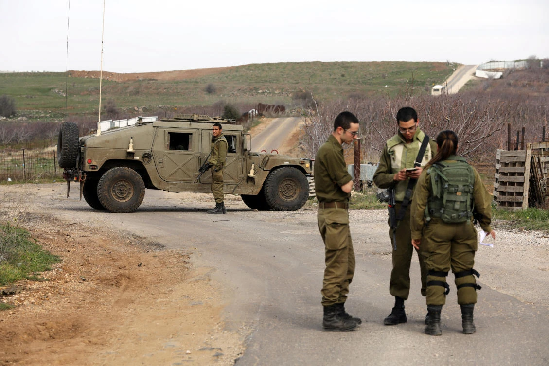 Israeli soldiers block a road near the Israeli border with Syria in the Israeli-occupied Golan Heights, Feb. 10, 2018. (Reuters)