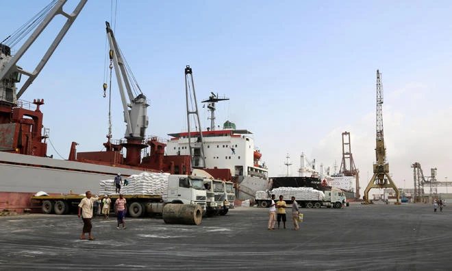 A crane unloads food aid provided by UNICEF from a cargo ship at the Red Sea port of Hodeida, Yemen. (AFP)