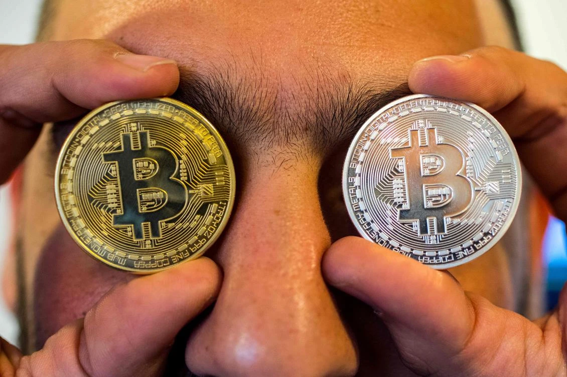 A person holding a visual representation of the digital crypto-currency Bitcoin. (AFP)