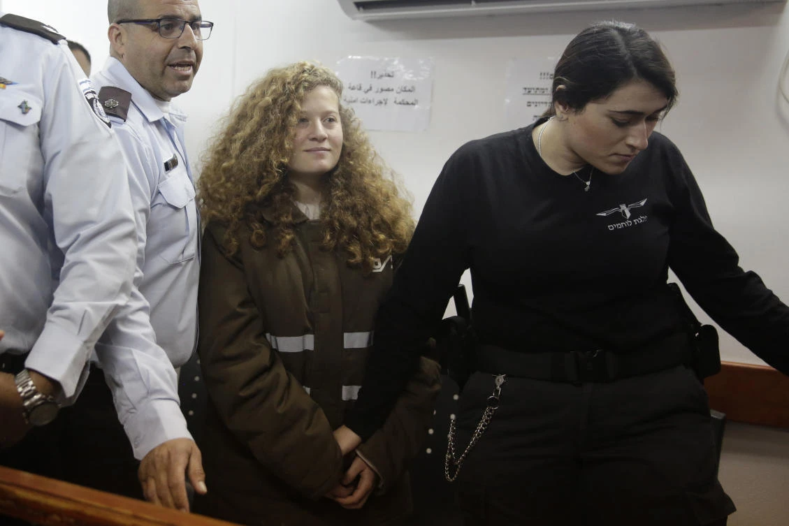 Ahed Tamimi is brought to a courtroom inside the Ofer military prison near Jerusalem in this January 15 photo. Tamimi will go on trial before an Israeli military court, for slapping and punching two Israeli soldiers in December. (AP)