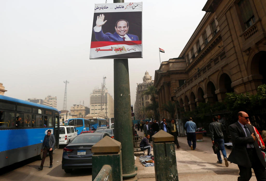 Egyptians walk in front of the Lawyers Syndicate near a poster of Egypt’s President Abdel Fattah El-Sisi for the upcoming presidential election, in Cairo, Egypt February 8, 2018. The poster reads: “Story of country will continue with you.” (Reuters)