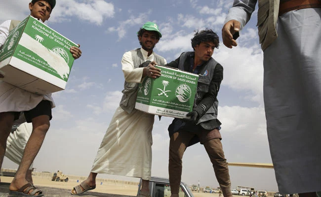Relief workers unload aid carried into Yemen by the Saudi military in Marib, Yemen, on Feb. 3, 2018. (AP Photo/Jon Gambrell)