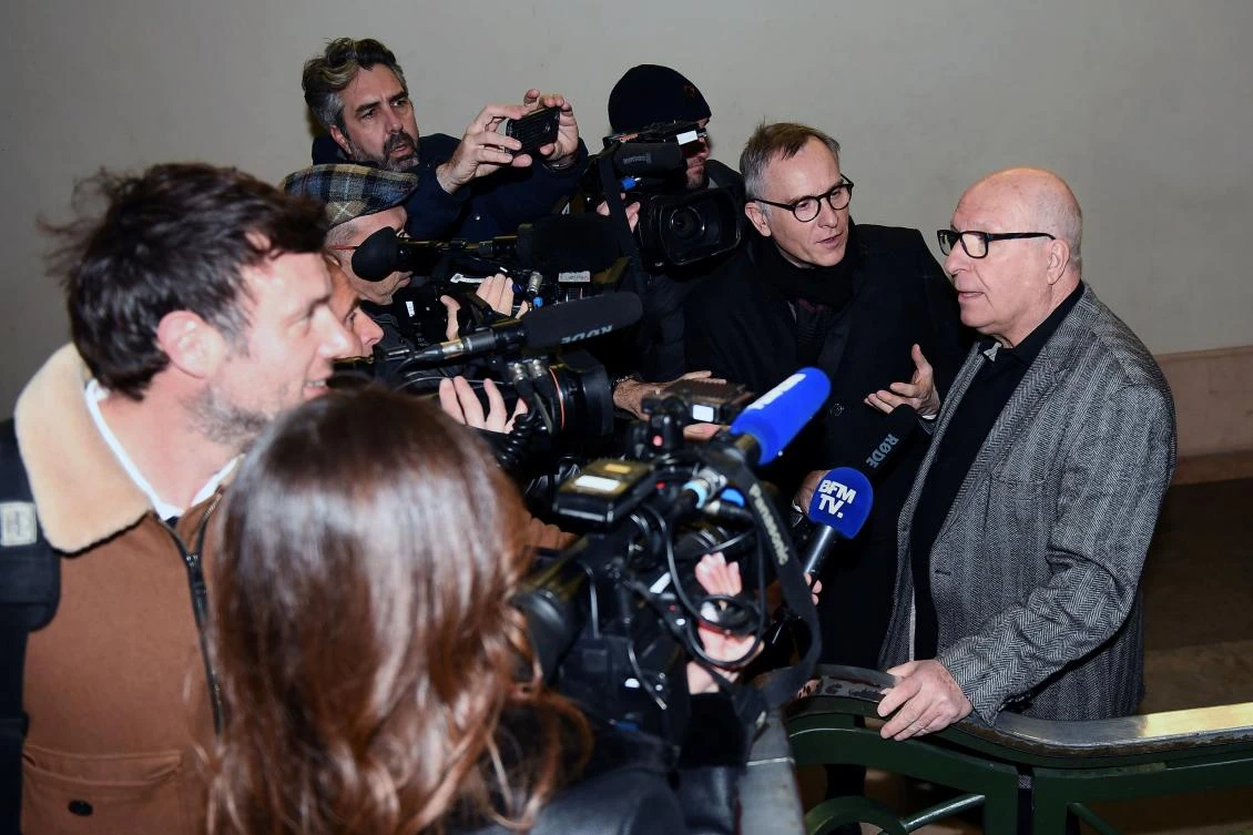 Jacques Cassandri, right, alleged 'brain' in the case of the 1976 spectacular burglary of the Societe Generale bank of Nice, answers journalists' questions on Monday at Marseille courthouse. (AFP)