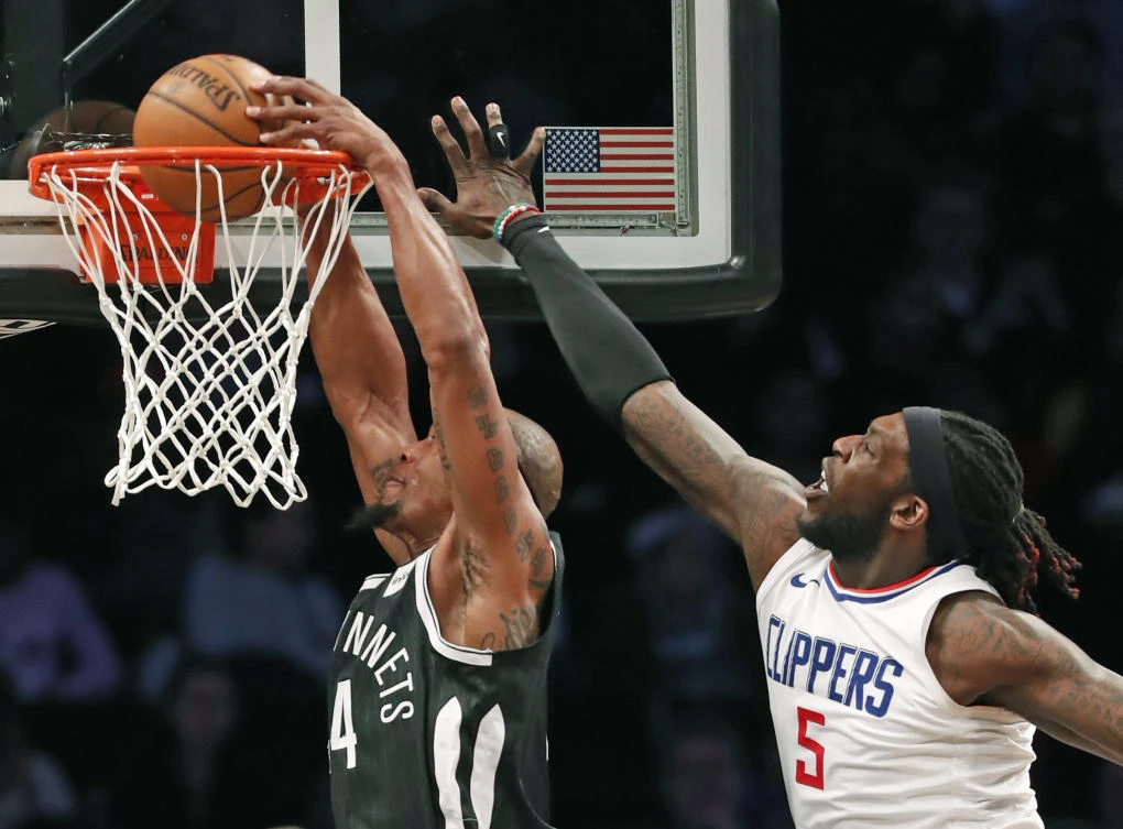 Los Angeles Clippers forward Montrezl Harrell (5) defends Brooklyn Nets Dante Cunningham (44) who dunks during the first half of an NBA basketball game, Monday, Feb. 12, 2018, in New York. (AP)